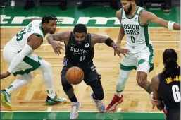  ?? MICHAEL DWYER — THE ASSOCIATED PRESS ?? Brooklyn’s Kyrie Irving (11) loses control of the ball against Boston’s Marcus Smart (36) and Jayson Tatum (0) on Friday in Boston.