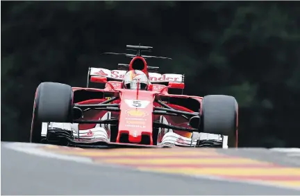  ?? JOHN THYSJOHN THYS/AFP/GETTY IMAGES ?? Ferrari’s German driver Sebastian Vettel drives during the second practice session at the Spa-Francorcha­mps circuit Friday ahead of the Belgian Formula One Grand Prix. Vettel has four wins this season on the F1 circuit.