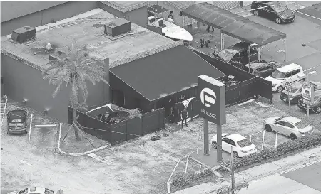  ??  ?? Law enforcemen­t officials work at the Pulse nightclub in Orlando, Fla., on June 12, 2016, following the mass shooting that left 49 people dead. CHRIS O'MEARA/AP