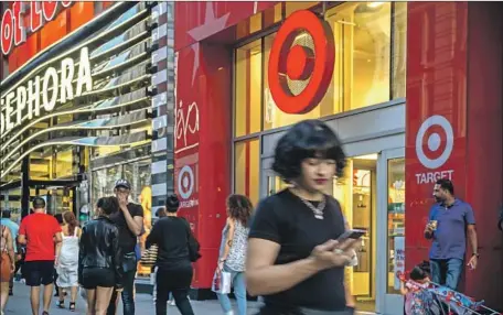  ?? Richard B. Levine Sipa USA ?? SHOPPERS outside a Target store in Manhattan. The major retailer’s holiday season sales growth fell well below the prior year’s mark.