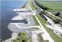  ?? ARMY CORPS OF ENGINEERS/COURTESY ?? The Herbert Hoover Dike was built after a 1928 Category 4 storm slammed into West Palm Beach and sent Lake Okeechobee rushing out of its banks.