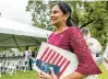  ?? ?? Above: Malini Ramella, from India, smiles after becoming a U.S. citizen.