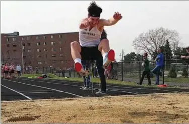  ?? CHRIS LILLSTRUNG — THE NEWS-HERALD ?? Mayfield’s Bobby Casey follows through on his area record-breaking long jump of 23-11 on April 13 during the South Invitation­al.