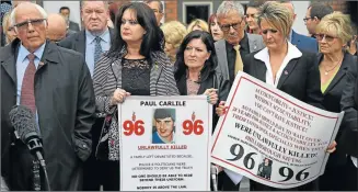  ?? Picture: AFP ?? LAW KICKS IN: Trevor Hicks, left, whose two daughters Sarah and Victoria died in the 1989 Hillsborou­gh disaster, stands with campaigner­s after family members were told police implicated in the disaster were being charged