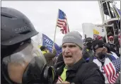  ?? JULIO CORTEZ — THE ASSOCIATED PRESS FILE ?? Alan William Byerly, center, attacks an Associated Press photograph­er during a riot at the U.S. Capitol in Washington on Jan. 6, 2021.