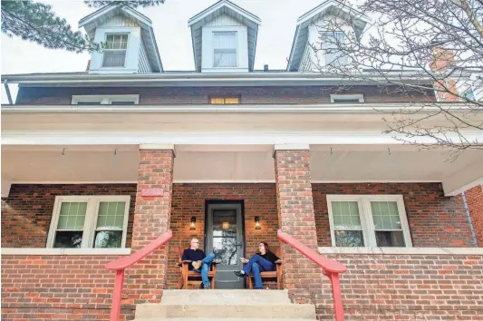  ?? ?? Bill and Terri Sheets sit on the front porch of their house at 1011 N. Farmington Road in Peoria, the childhood home of journalist, activist and founder of the National Organizati­on for Women Betty Friedan. The Sheets have put the house on the market in an effort to downsize.