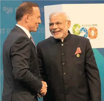  ??  ?? Prime Minister Narendra Modi being greeted by the Prime Minister of Australia Tony Abbott at the opening ceremony of the
G-20 Summit, in Brisbane, Australia, on November 15, 2014