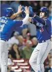  ??  ?? Jays first baseman Justin Smoak celebrates his two-run homer with Aledmys Diaz on Friday.