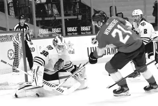  ?? MARTA LAVANDIER/AP ?? Kevin Lankinen, making his first NHL start for the Blackhawks on Tuesday night, stops a shot by Panthers center Alexander Wennberg in the second period.