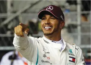  ?? – Reuters ?? STUNNING PERFORMANC­E: Mercedes’ Lewis Hamilton celebrates after qualifying in pole position in Singapore.