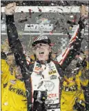  ?? John Raoux ?? The Associated Press NASCAR Cup Series “Young Gun” Erik Jones exults after his Coke Zero Sugar 400 victory on Saturday at Daytona Internatio­nal Speedway.