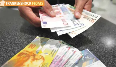  ??  ?? An illustrati­on picture shows a clerk as he exchanges Swiss francs into Euros at a counter in a Swiss Post office in Bern, Switzerlan­d. — Reuters