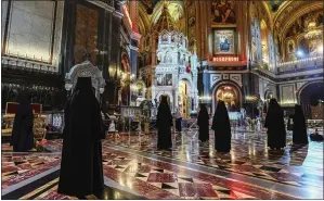  ?? OLEG VAROV, RUSSIAN ORTHODOX CHURCH PRESS SERVICE VIA AP ?? Russian Orthodox Church nuns observe social distancing guidelines as they attend the church’s celebratio­n of Orthodox Easter at Christ the Savior Cathedral in Moscow on Sunday.