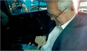  ?? AFP ?? David Davis writes a message on his phone after an interview in London. —