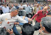  ?? /Reuters ?? Target: A victim is rushed away from the scene of a bomb blast at a Coptic church in Tanta, Egypt.