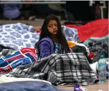  ??  ?? Central American migrants travelling in the “Migrant Via Crucis” caravan bed down outside “El Chaparral” port of entry to US