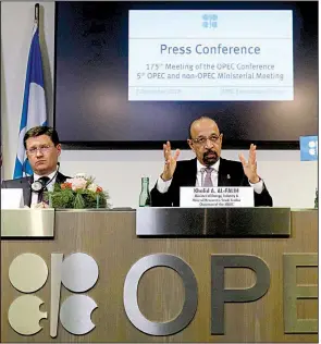  ?? AP/RONALD ZAK ?? Russian Energy Minister Alexander Novak (left) and Khalid Al-Falih, Saudi Arabian minister of energy, industry and mineral resources, discuss the decision to cut oil production Friday in Vienna.