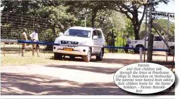  ??  ?? Parents and their children talk through the fence at Peterhouse College in Marondera on Wednesday. The parents were barred from taking their children home for the Easter holidays. – Picture: Rutendo Rori