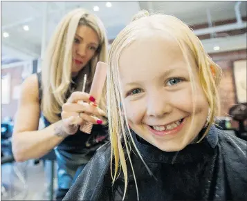  ?? ARLEN REDEKOP/PNG ?? Mila Shannon donates her locks for Wigs for Kids in memory of her stillborn sister Elizabeth at Avant Garde Hair Studio in Vancouver on Thursday.