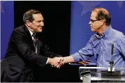  ?? DARRON CUMMINGS / AP ?? Democratic Sen. Joe Donnelly (left) shakes hands with Republican former state Rep. Mike Braun after a U.S. Senate debate in Indianapol­is recently.