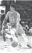  ?? Woody Marshall/Associated Press ?? ■ North Carolina’s Cameron Johnson (13) gets around the defense of Wake Forest’s Torry Johnson (4) on Saturday during the second half of an NCAA basketball game in Winston-Salem, N.C.