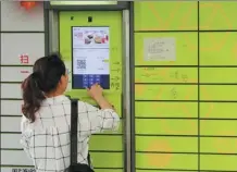  ?? WANG QIMING / FOR CHINA DAILY ?? A woman retrieves a package from a Hive Box locker in Changzhou, Jiangsu province, on Saturday.