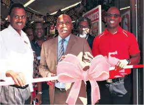  ??  ?? With hundreds of locals and many VIP’s looking on, Shoprite Regional Manager Collin Govindasam­y and Deputy Divisional Manager Andrew Siqwanazi celebrate as Mtubatuba Mayor Cllr Velangenko­si Gumede cuts the ribbon to officially open the store