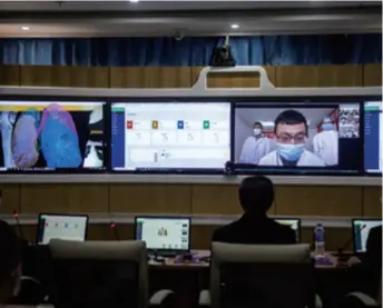  ??  ?? Doctors use remote consultati­on systems based on artificial intelligen­ce and 5G technologi­es to check lungs of patients at the First Affiliated Hospital of Kunming Medical University in Kunming, Yunnan Province in southwest China, on March 2