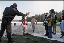  ?? LAUREN HALLIGAN — MEDIANEWS GROUP FILE ?? Polar Plunge participan­ts get a high five after enduring frigid water temperatur­es at the 34th Annual Winter Festival at Grafton Lakes State Park.