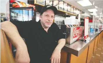  ?? — PIERRE OBENDRAUF ?? Johnny Tzouvelako­s, seen inside his Lasalle Drive-in on Tuesday, is rehiring but he’s having trouble getting some employees to come back to work