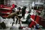  ?? RICHARD TSONG-TAATARII/STAR TRIBUNE VIA AP ?? In this Wednesday, May 27 photo, a looter uses a claw hammer as he tries to break in to a cash register at a Target store in Minneapoli­s. Rioters ignited fires and looted stores all over the city, as peaceful protests turned increasing­ly violent in the aftermath of the death of George Floyd.