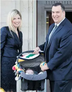  ?? ADRIAN WYLD/THE CANADIAN PRESS FILES ?? James Moore, seen with his wife Courtney Payne and son Spencer in Ottawa in July 2013, announced he will not run for re-election in the upcoming federal election after Spencer was recently diagnosed with skeletal dysplasia.