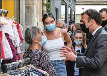  ??  ?? French President Emmanuel Macron visits with residents Tuesday in the city of Valence. (AP/Philippe Desmazes)