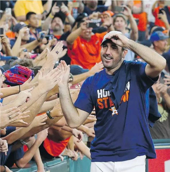  ?? — GETTY IMAGES ?? Houston ace Justin Verlander celebrates with the fans after the Astros toppled the Seattle Mariners 7-1 to win the American League West crown at Minute Maid Park on Sunday in Houston.