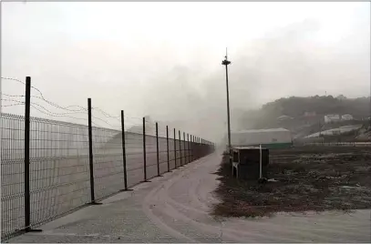  ?? ORVIL SAMUEL / AP ?? A road is blanketed in volcanic ash Saturday at the internatio­nal airport in Kingstown, on the eastern Caribbean island of St. Vincent.