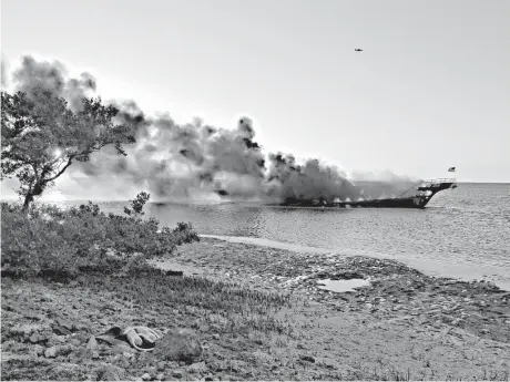  ?? Tambrey Laine/Pasco County via Associated Press ?? Flames engulf a boat Sunday in the Tampa Bay, Florida, area. Florida authoritie­s say the casino venture’s shuttle boat caught fire on Sunday, and dozens of passengers safely made it to shore in Port Richie after a rescue operation.