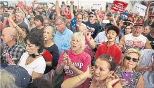  ?? JOE RAEDLE GETTY IMAGES ?? Cesar Sayoc, far right in red hat, was arrested on allegation­s that he sent bombs to Trump critics.