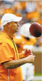  ?? STAFF PHOTO BY C.B. SCHMELTER ?? Tennessee football coach Jeremy Pruitt tosses a football in the air during the Orange and White at Neyland Stadium on April 13.