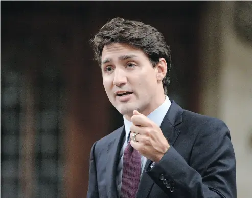  ?? ADRIAN WYLD / THE CANADIAN PRESS ?? Prime Minister Justin Trudeau says a Chinese state- owned company’s $1.5-billion bid to take over Calgary constructi­on firm Aecon Group will be reviewed “very carefully” under the Canada Investment Act.
