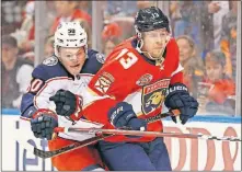  ?? [WILFREDO LEE/THE ASSOCIATED PRESS] ?? Blue Jackets left wing Eric Robinson and Panthers defenseman Mark Pysyk fight for the puck during the first period.