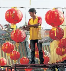  ?? SAKCHAI LALIT/THE ASSOCIATED PRESS ?? A Thai worker decorates lanterns for celebratio­ns of Chinese New Year at the Leng Nuei Yee Chinese temple in Bangkok, Thailand, on Wednesday.