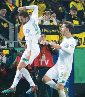  ?? Foto: dpa ?? Der Bremer Martin Harnik (links) jubelt vor der schwarz-gelben Wand in Dortmund. Die Gäste von der Weser gewannen im Elfmetersc­hießen gegen Borussia Dortmund und stehen im Viertelfin­ale des DFB-Pokals.