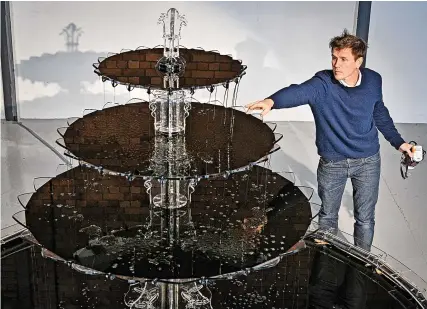  ?? Pics: Finnbarr Webster/Getty Images ?? Artist Luke Jerram with his new environmen­tal artwork Oil Fountain in Bristol yesterday