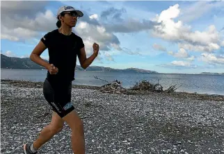  ?? PHOTO: MATTHEW TSO/FAIRFAX NZ ?? Neelu Jennings runs on the Petone foreshore to prepare for the Crazyman multisport race.