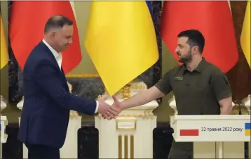  ?? EFREM LUKATSKY — THE ASSOCIATED PRESS ?? Ukrainian President Volodymyr Zelenskyy, right, and Polish President Andrzej Duda shake hands Sunday after their meeting in Kyiv, Ukraine. Duda’s visit came as Russian and Ukrainian forces battled in the eastern industrial heartland.