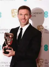  ??  ?? Animator Travis Knight holds his BAFTA award for Best Animated Film for “Kubo And The Two Strings”.