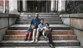  ?? Photos by Adam Ferguson / New York Times ?? Jacques David, 50, with his wife and children in Brooklyn.