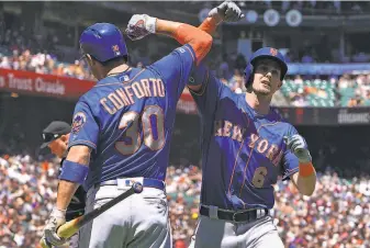  ?? Thearon W. Henderson / Getty Images ?? The Mets’ Jeff McNeil is congratula­ted by teammate Michael Conforto after McNeil’s tworun homer in the fifth inning. New York had four home runs in its win at Oracle Park.