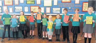  ??  ?? Pupils from Bollington St John CoE Primary School after it received an ‘outstandin­g’ mark in its recent Statutory Inspection of Anglican and Methodist Schools (SIAMS) Report