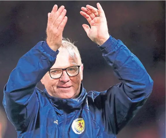  ?? Pictures: SNS. ?? Alex McLeish and his Scotland players, right, salute the Tartan Army after their thrilling victory over Israel at Hampden.